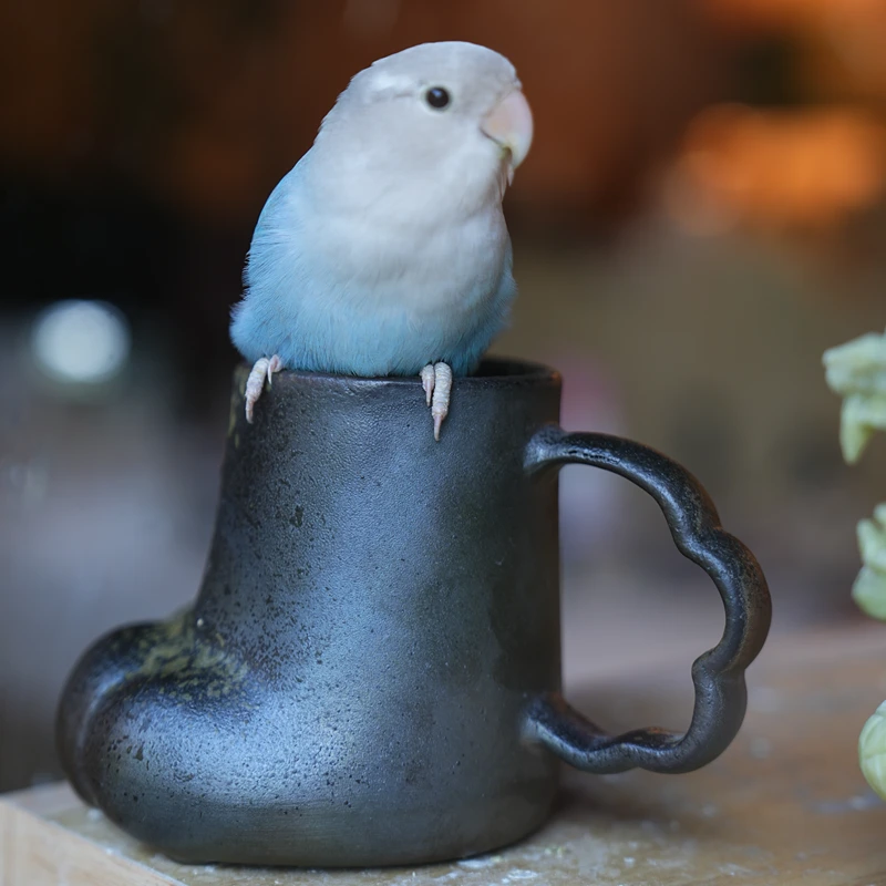 Handmade cat paw ceramic mug displayed with home décor in a cozy setting